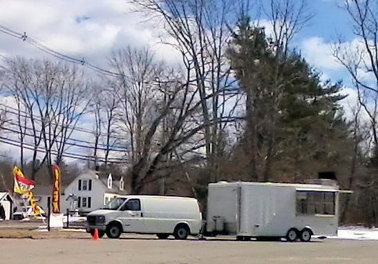 Larry Joe's white van and trailer, with large windows
