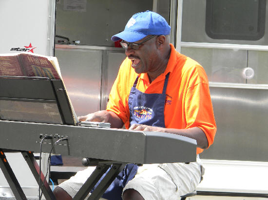 Larry Joe outside his van, playing blues on keyboard