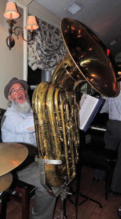 Al Bernard making a face and holding a very large tuba