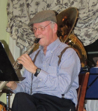 Craig Ball in tweed flat cap and suspenders on soprano sax