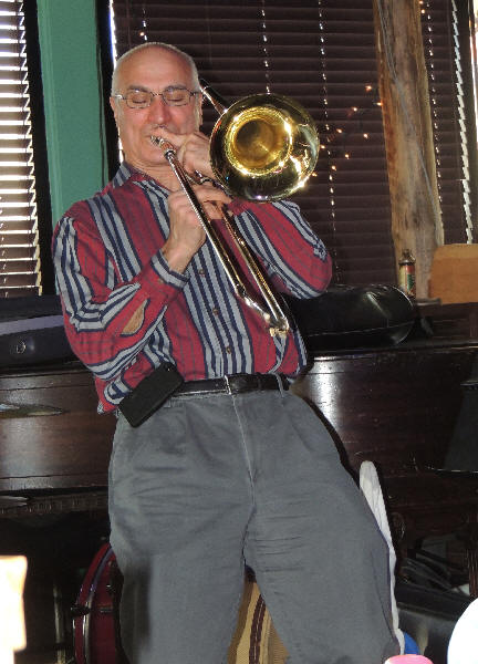 Lee Prager leaning backwards, playing trombone