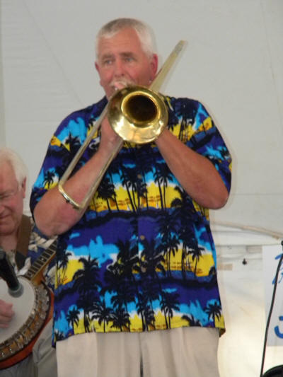 Skip on trombone, in blue & yellow Hawaiian shirt